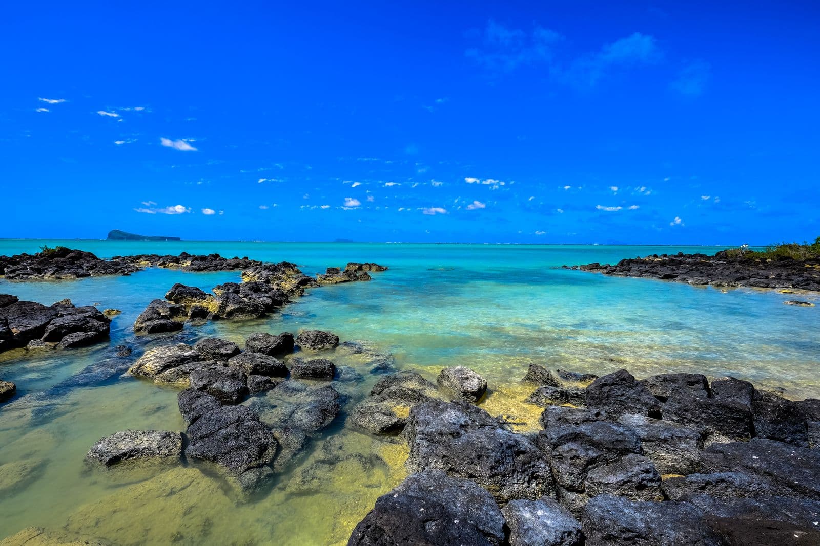 Turquoise lagoon and volcanic rocks on the Mauritius coast